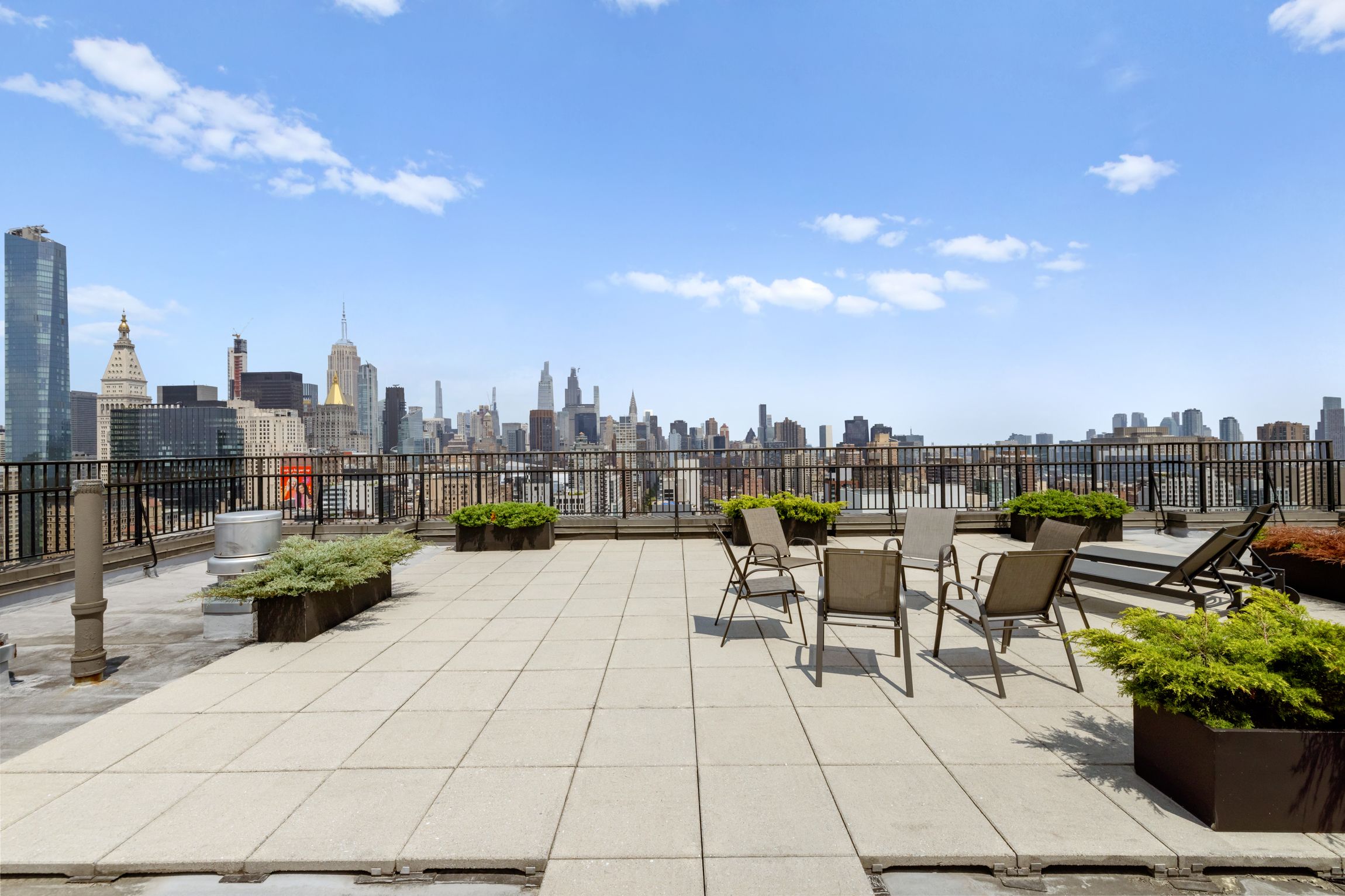 201 East 17th Street, Unit 15H Manhattan, NY 10003 - Photo 17 of 24 a view of roof deck with lawn chairs and potted plants