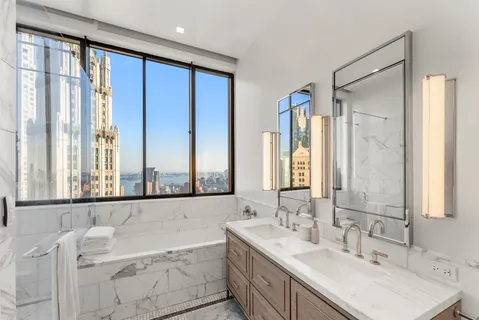 a bathroom with a double vanity sink and a mirror