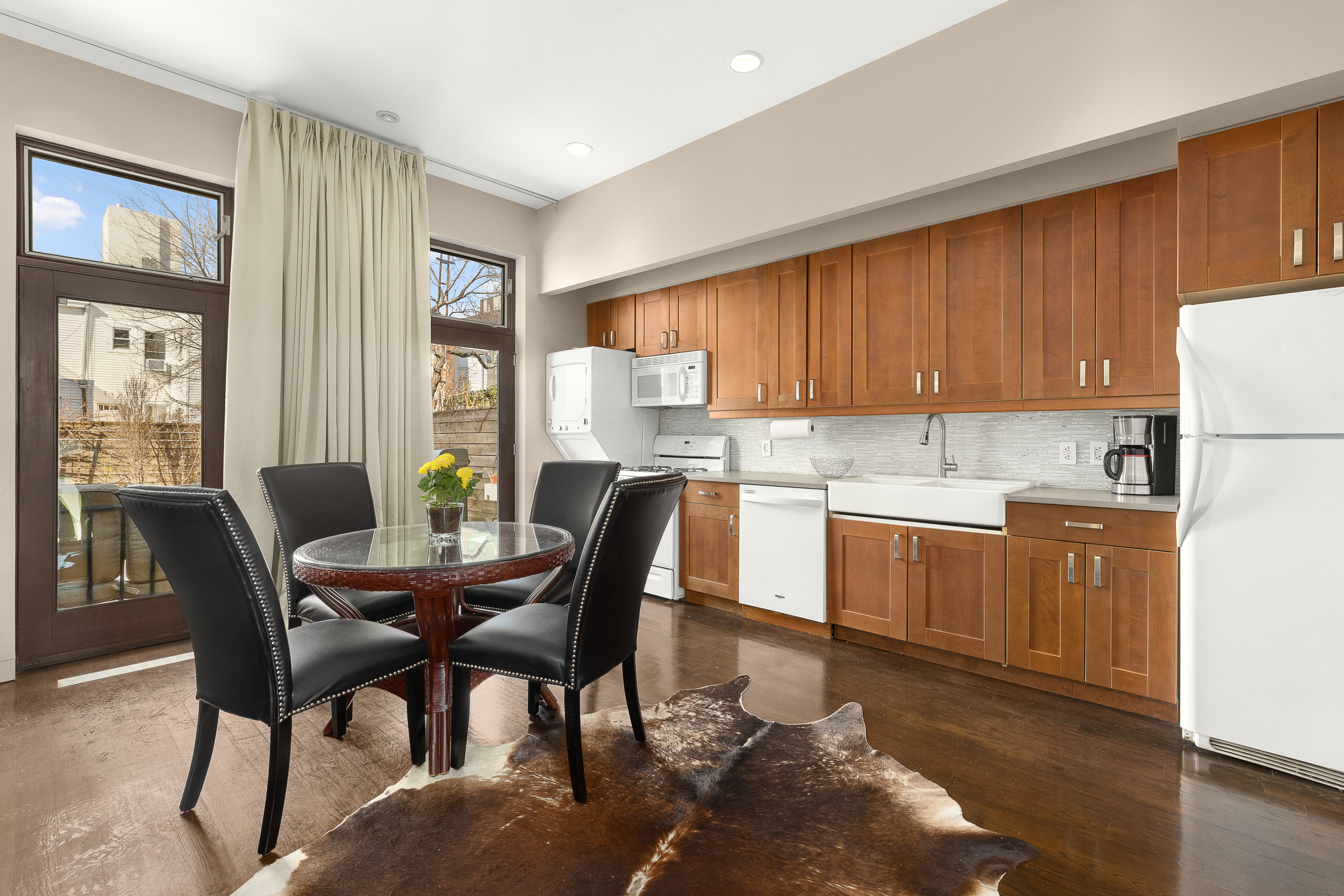 38-06 28th Street, Unit 1 Queens, NY 11101 - Photo 3 of 8 a kitchen with a dining table chairs and refrigerator