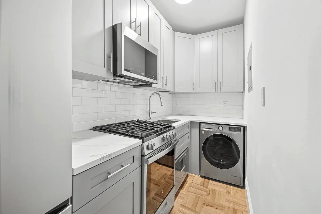 132 West 80th Street, Unit 4R Manhattan, NY 10024 - Photo 3 of 6 a utility room with sink washer and dryer