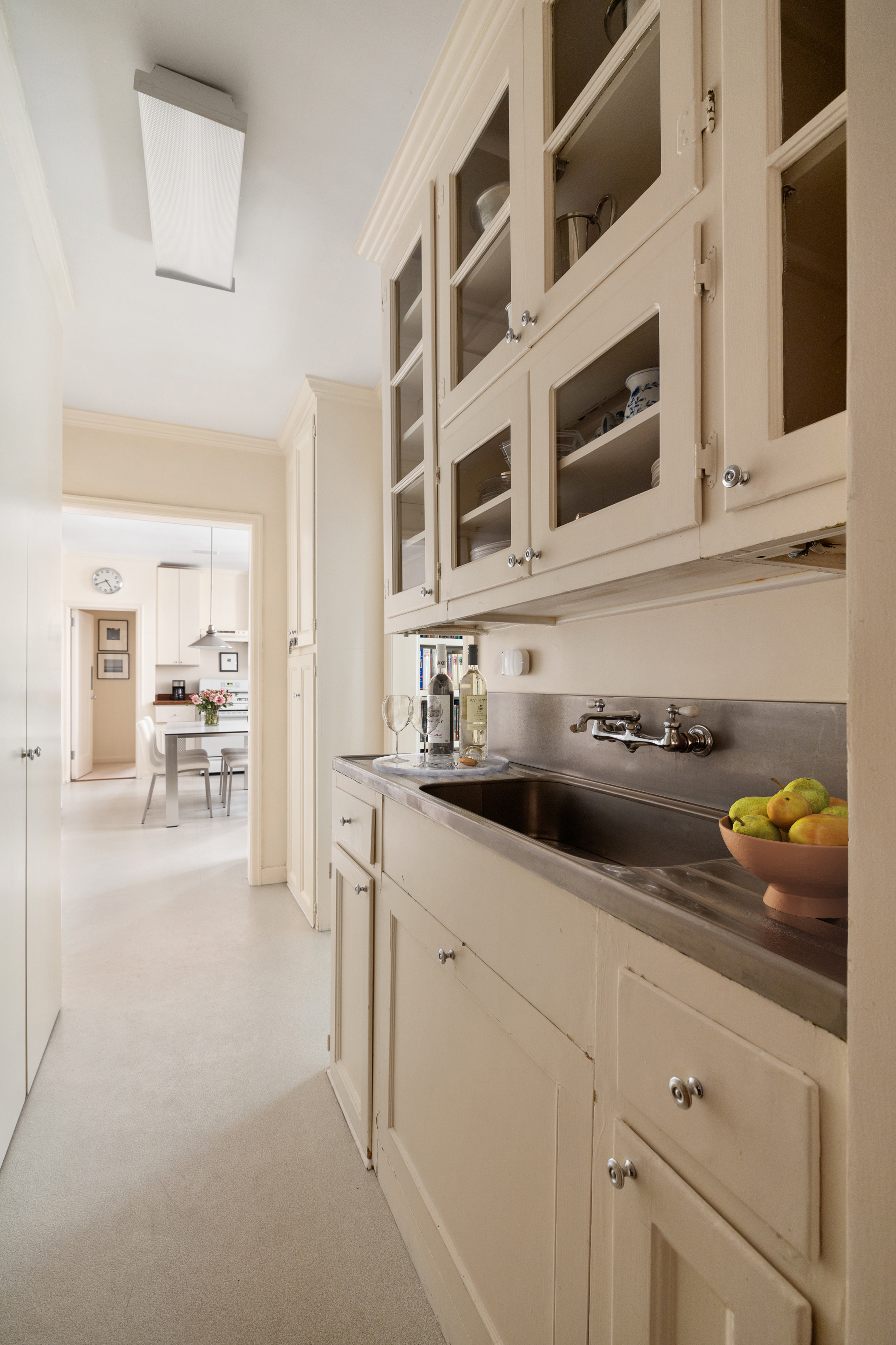 116 East 68th Street, Unit 2D Manhattan, NY 10065 - Photo 7 of 12 a kitchen with stainless steel appliances a sink and cabinets