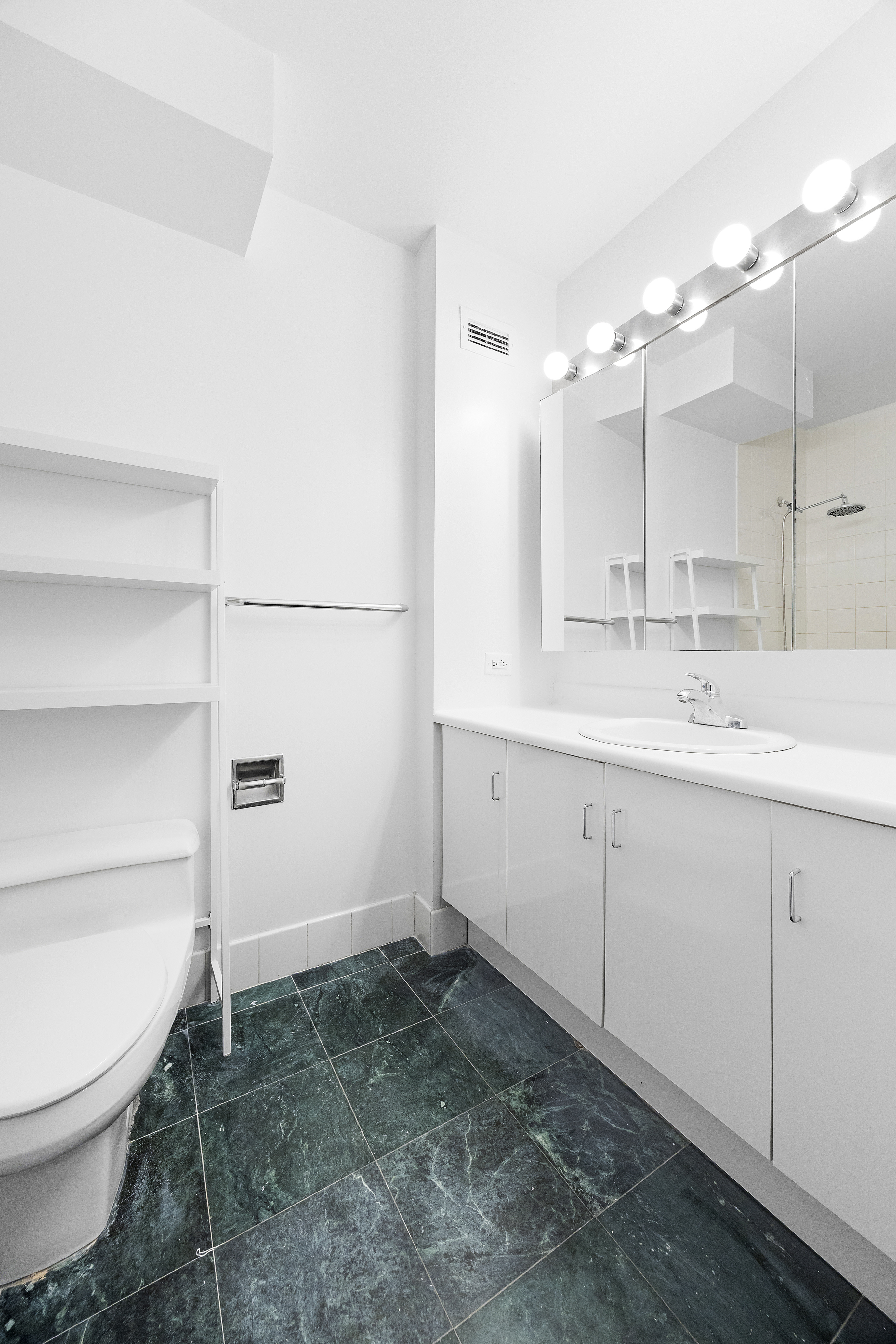 2250 Broadway, Unit 5H Manhattan, NY 10024 - Photo 8 of 9 a bathroom with a sink a toilet and mirror