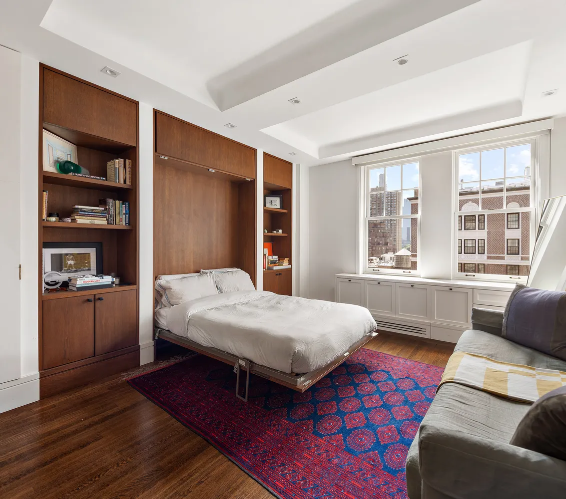 a bedroom with a bed and a couch