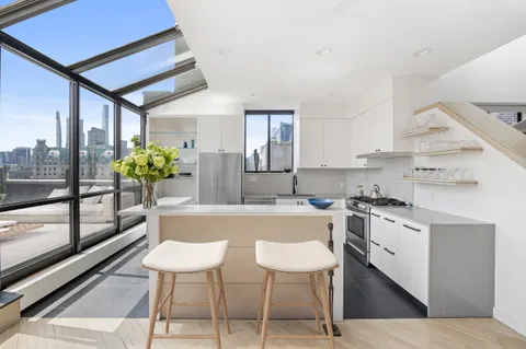a kitchen with a table chairs stove and cabinets
