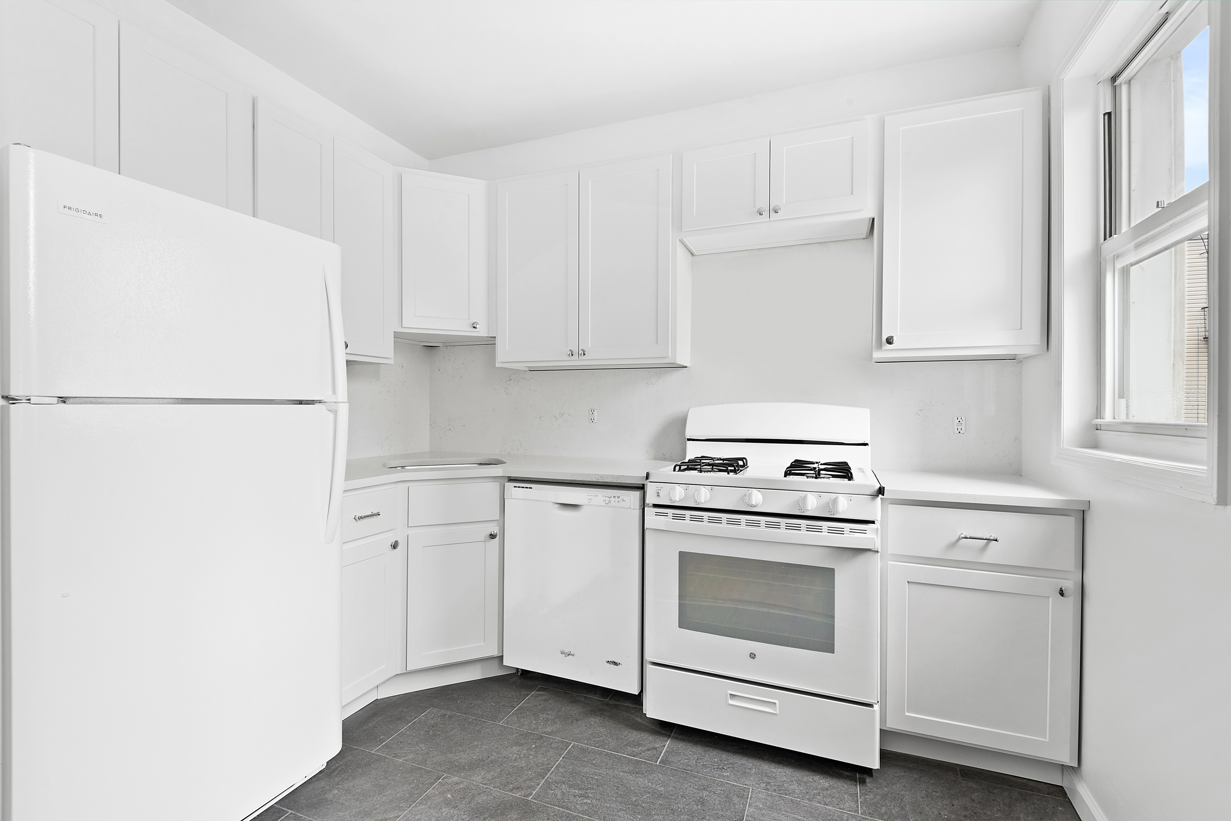 59 Stagg Street, Unit 3 Brooklyn, NY 11206 - Photo 4 of 8 a kitchen with cabinets appliances and a window