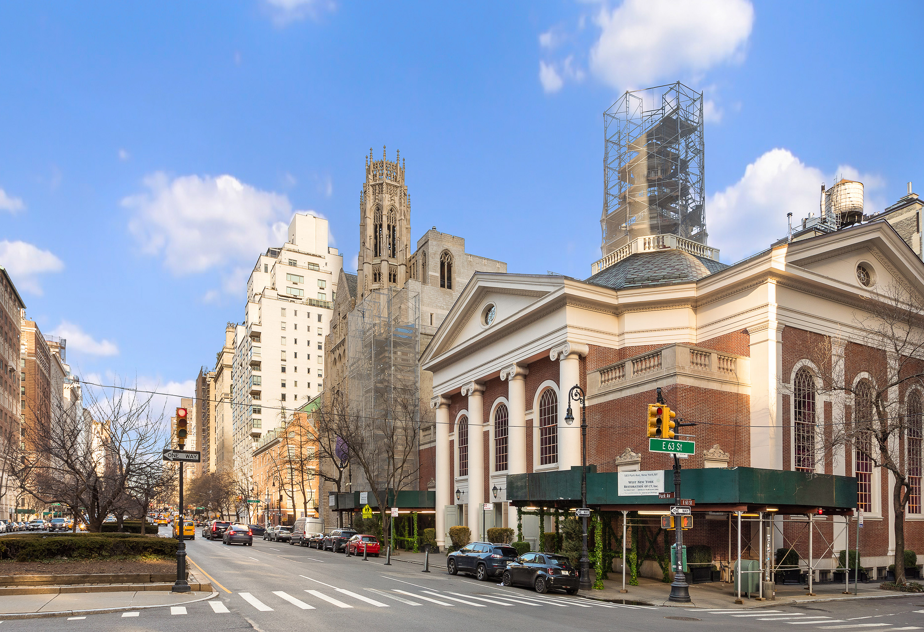 575 Park Avenue, Unit 407 Manhattan, NY 10065 - Photo 12 of 14 a front view of a building with lot of cars and trees