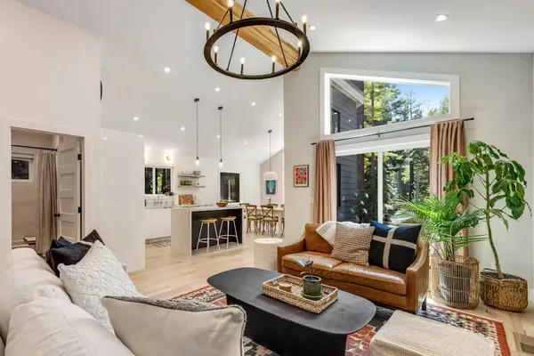 a living room with furniture a dining table and a large window