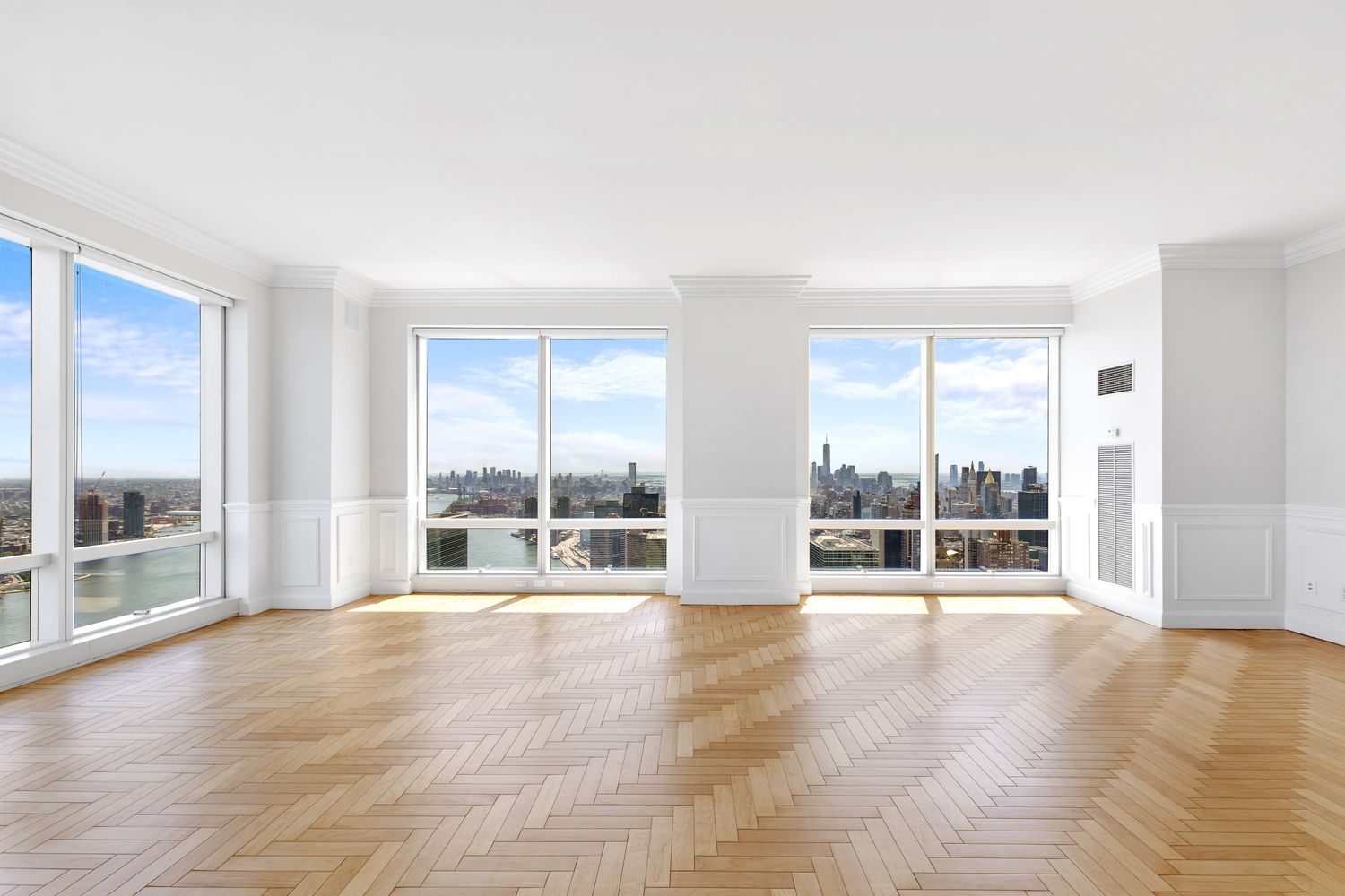 845 United Nations Plaza, Unit 63B Manhattan, NY 10017 - Photo 3 of 14 a view of an empty room with wooden floor and a window