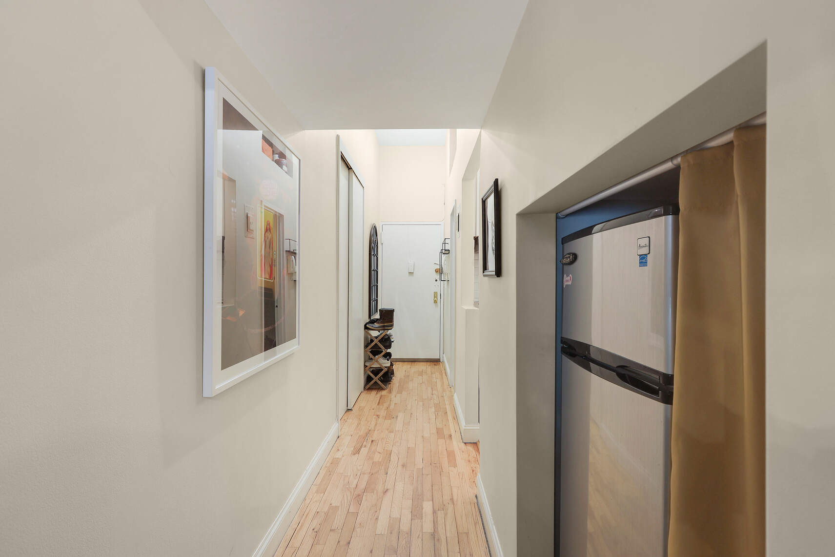 310 East 23rd Street, Unit 7C Manhattan, NY 10010 - Photo 11 of 18 a view of a hallway with wooden floor and closet