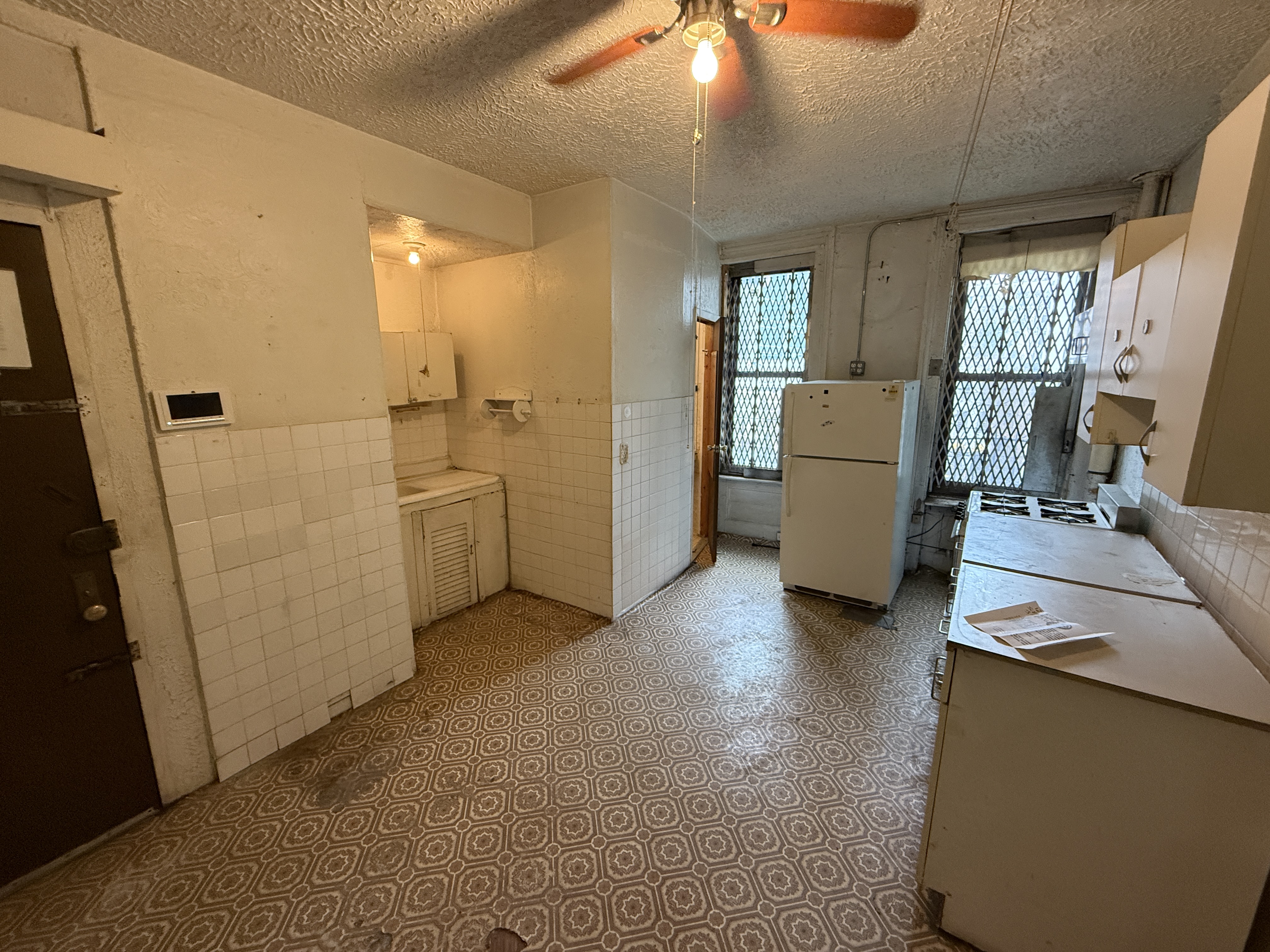 320 West 47th Street, Unit 4W Manhattan, NY 10036 - Photo 2 of 11 a view of a kitchen with fridge and workspace