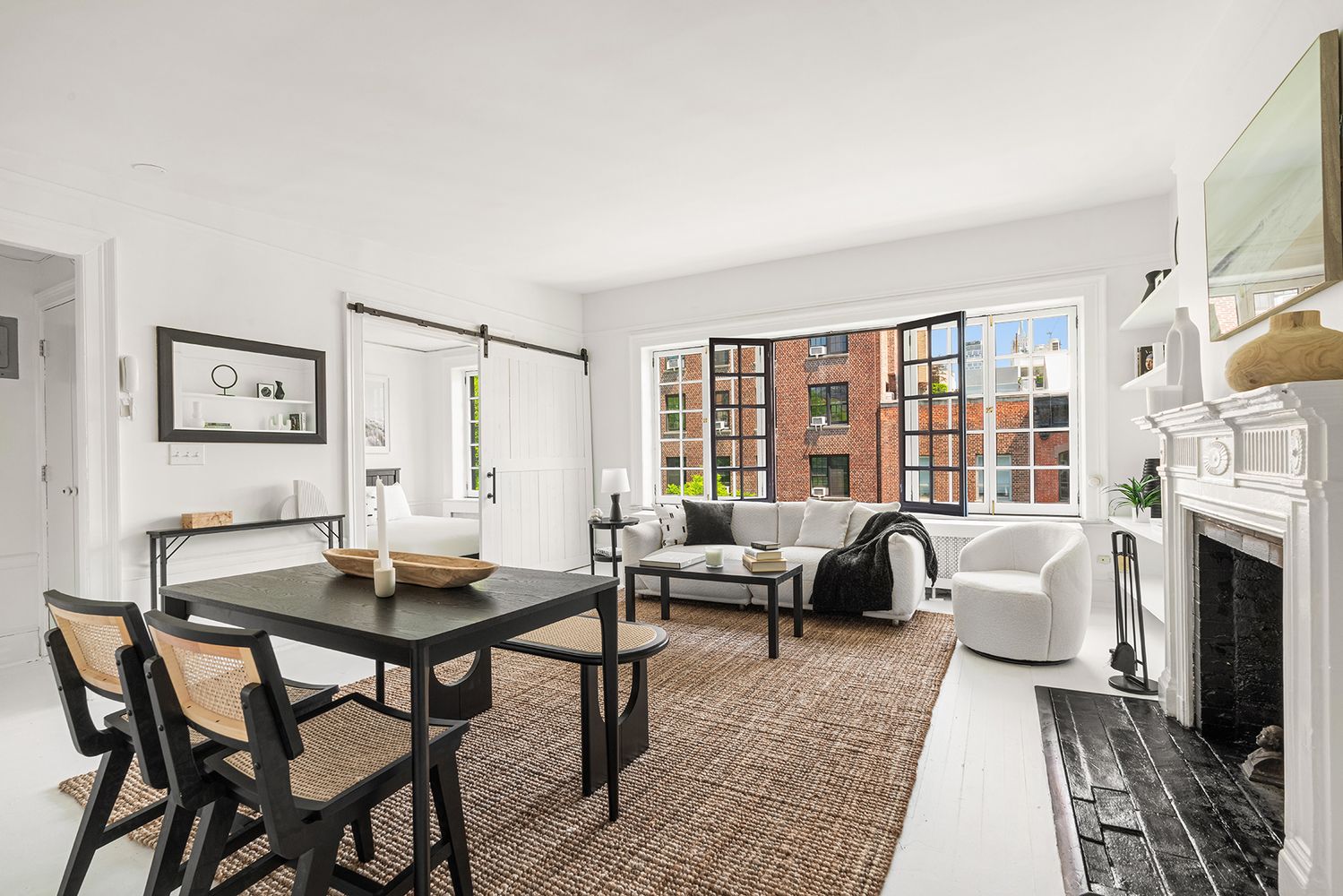 30-32 West 9th Street, Unit 5A Manhattan, NY 10011 - Photo 6 of 18 a living room with furniture and a fireplace