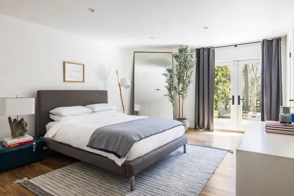 a bedroom with a large bed and a large window