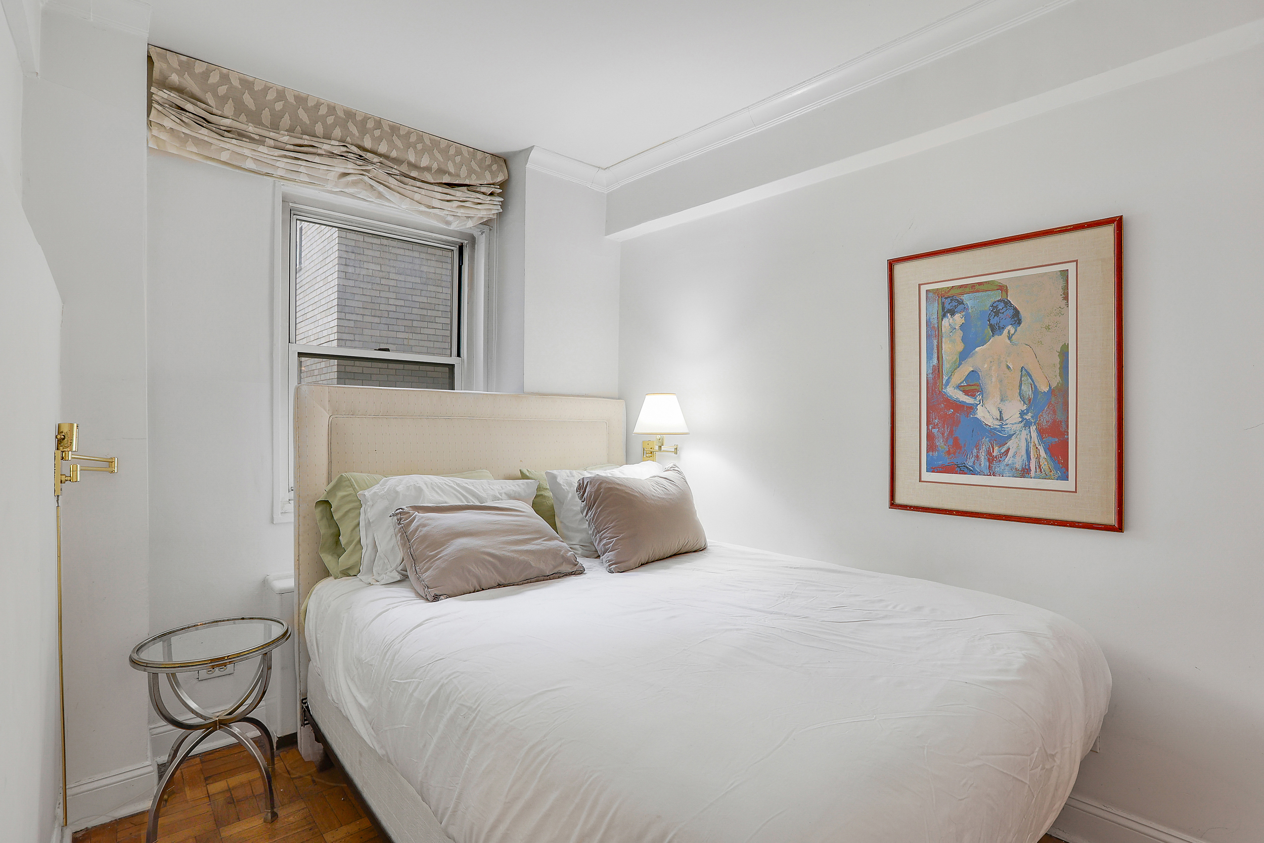 100 West 57th Street, Unit 15N Manhattan, NY 10019 - Photo 5 of 9 a bedroom with a bed and painting on the wall