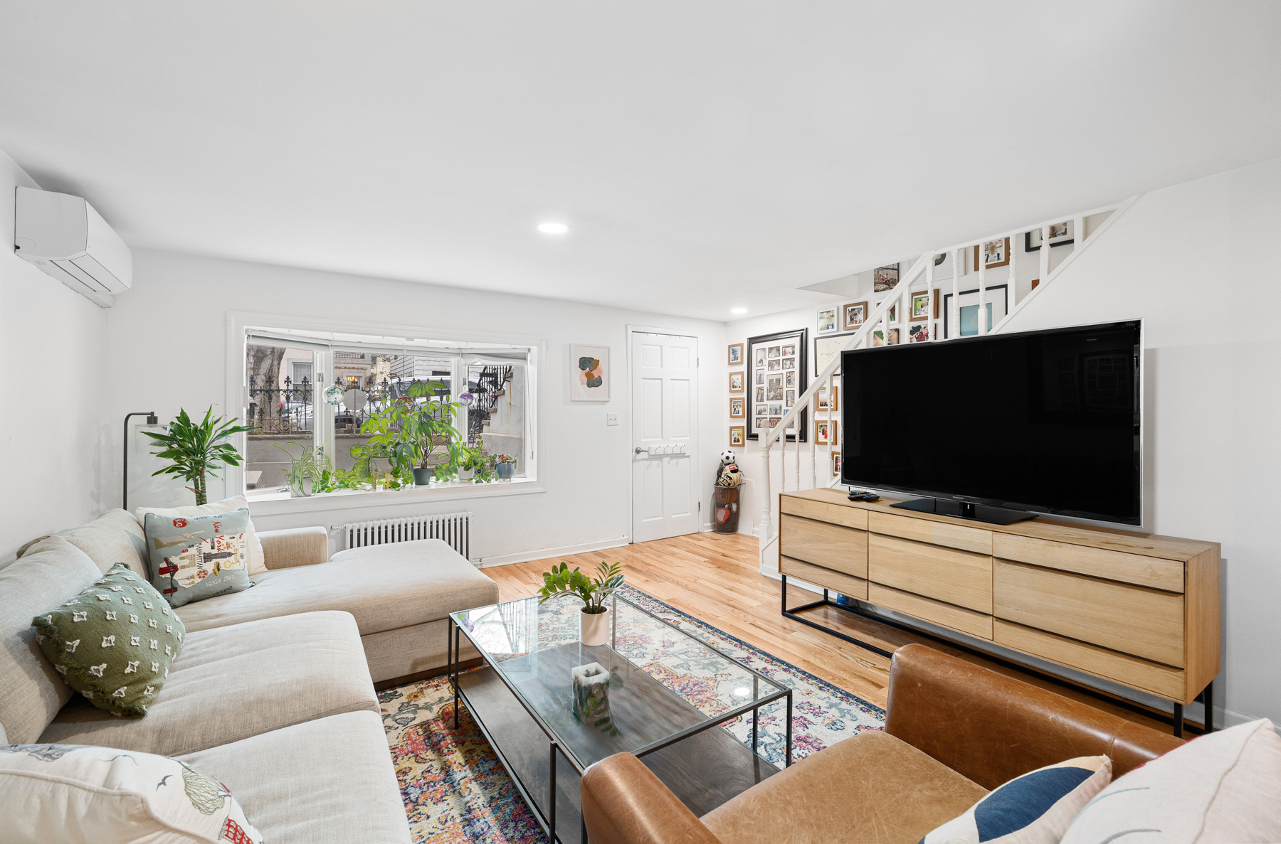 202 22nd Street Brooklyn, NY 11232 - Photo 3 of 28 a living room with furniture and a flat screen tv