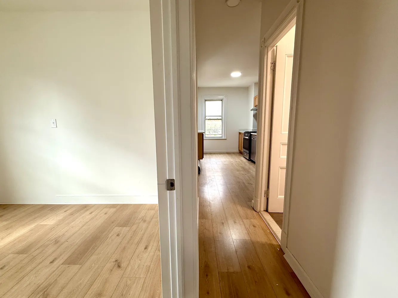 a view of a hallway with wooden floor