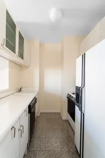 a kitchen with a stove and a refrigerator