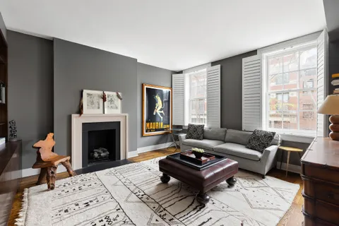 a living room with a fireplace and a rug