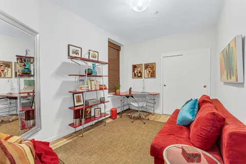 a living room with furniture cabinets and book shelf