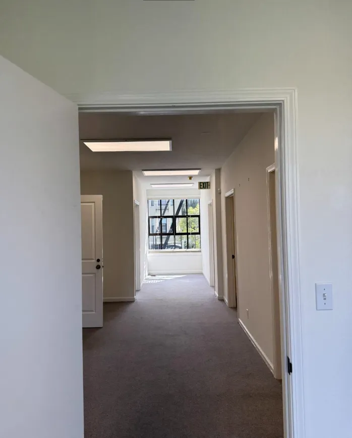 a view of a room with an empty space and window