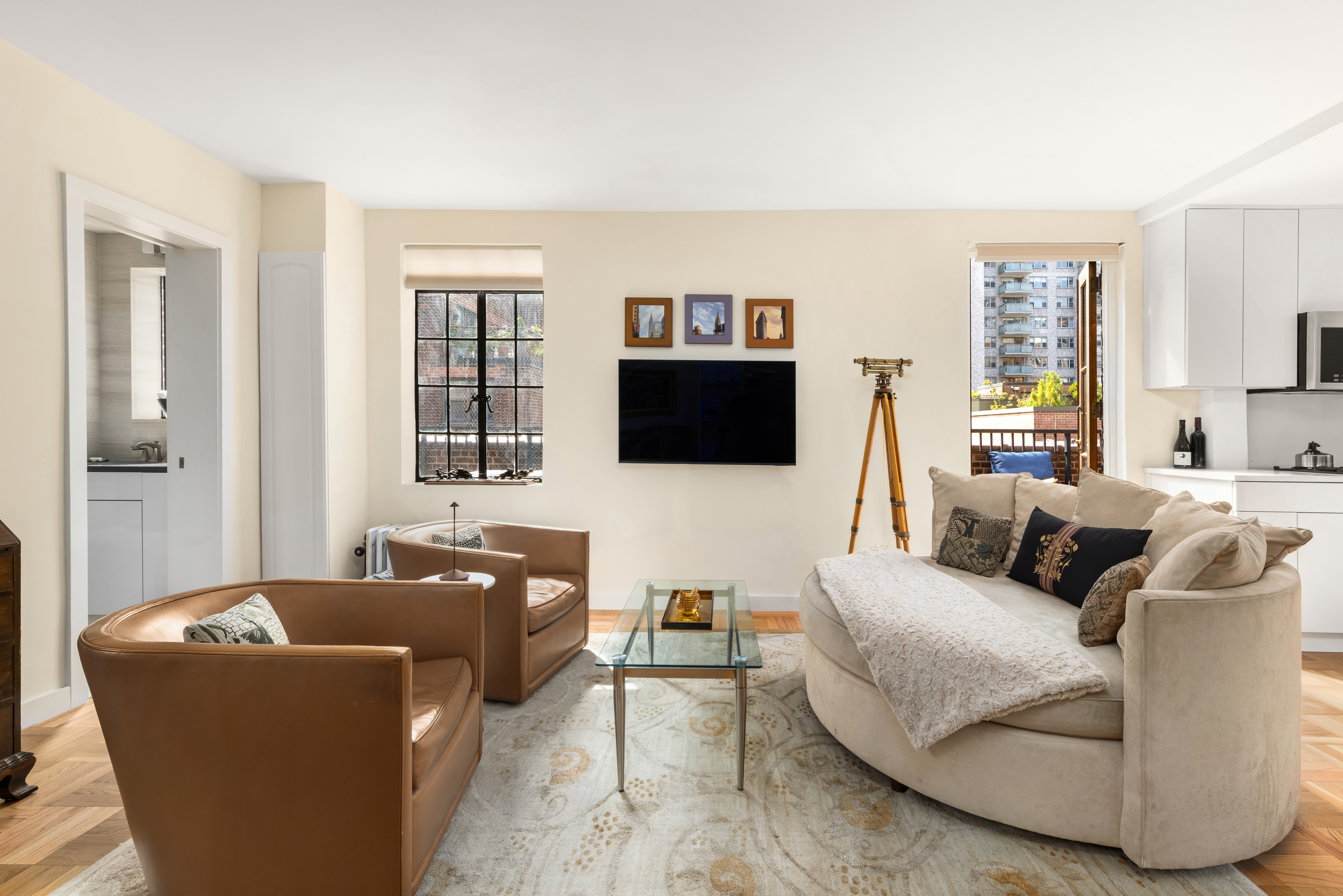 324 East 41st Street, Unit 1103C Manhattan, NY 10017 - Photo 5 of 13 a living room with furniture and a flat screen tv