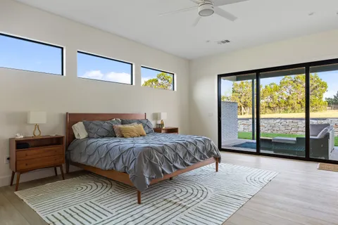 a bedroom with a large bed and a large window