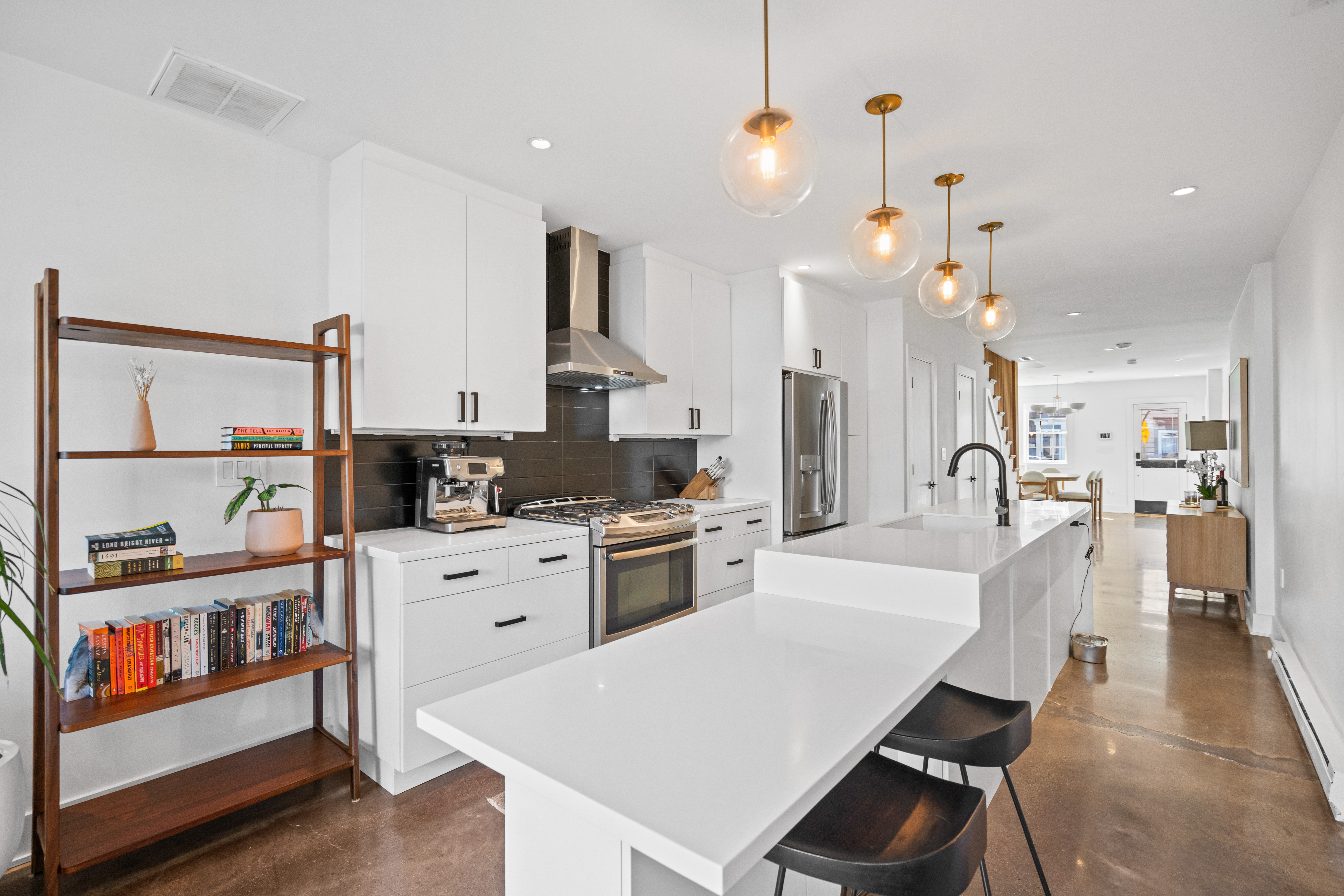 445 Ridge Street Northwest Washington, DC 20001 - Photo 11 of 43 a large kitchen with white cabinets and stainless steel appliances