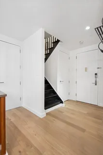 a view of an empty room with stairs and ventilation