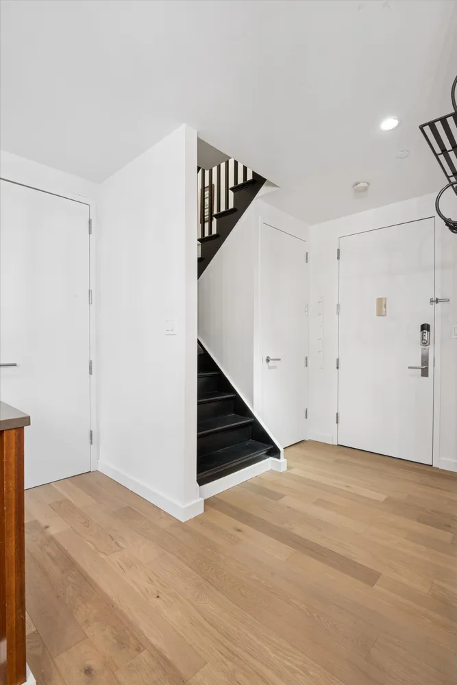 a view of an empty room with stairs and ventilation