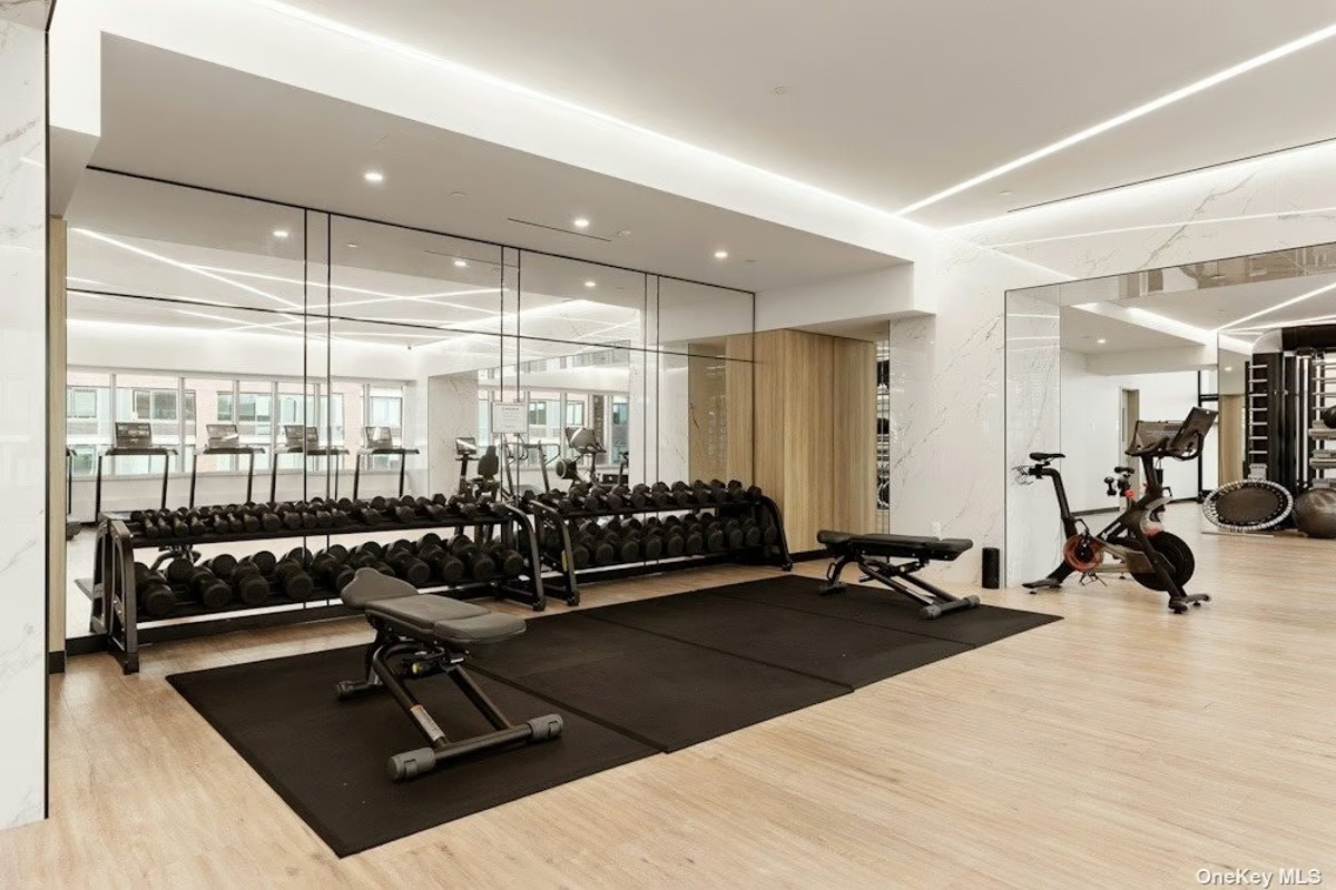 46-30 Center Boulevard, Unit PH8 Queens, NY 11109 - Photo 24 of 32 a room with gym equipment and view of living room