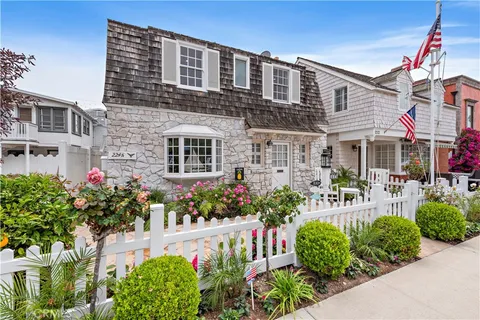 a front view of a house with a yard and flowers