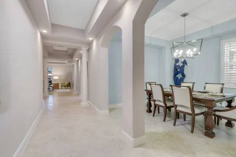 a view of a dining room with furniture and chandelier