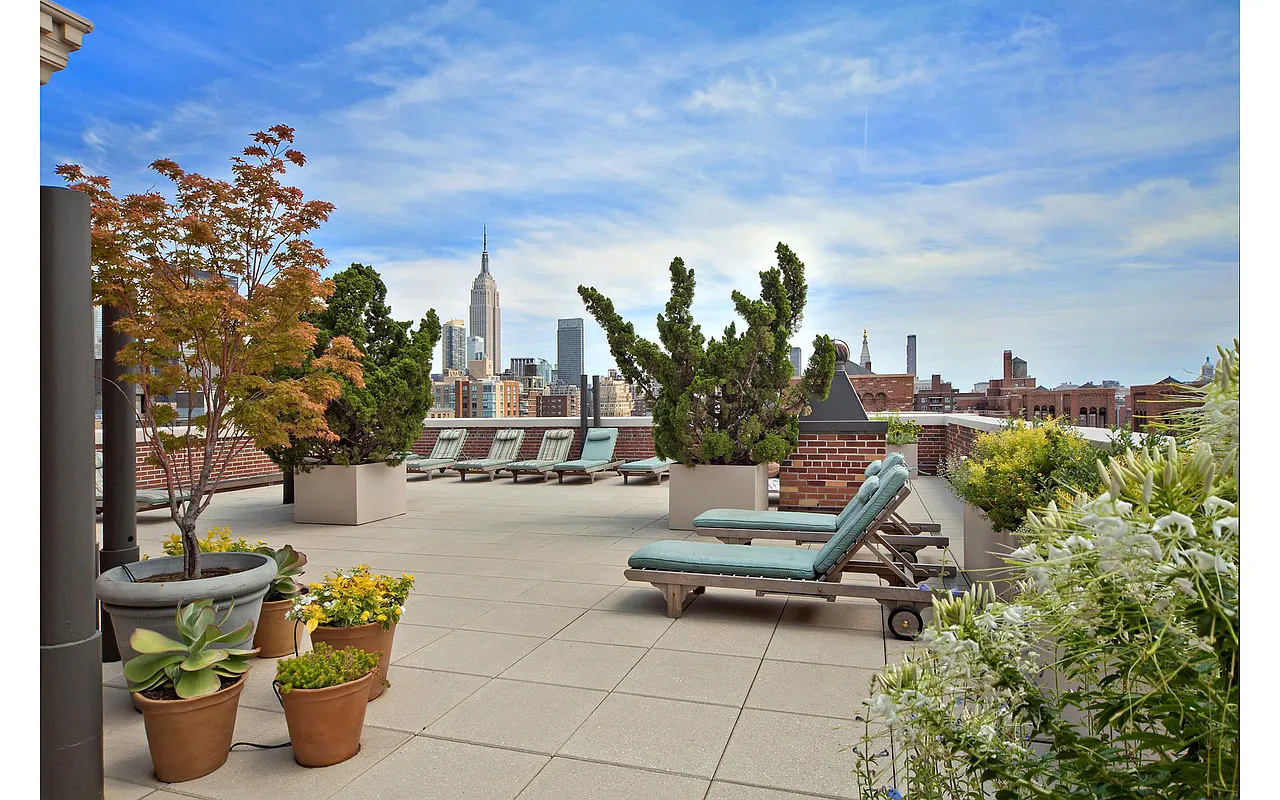 470 West 24th Street, Unit 16H Manhattan, NY 10011 - Photo 11 of 13 a view of a terrace with chairs potted plants and a fountain