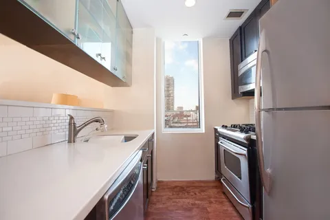 a kitchen with a sink stove and refrigerator