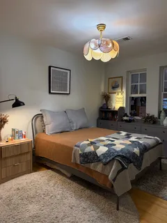 a bedroom with bed and a chandelier