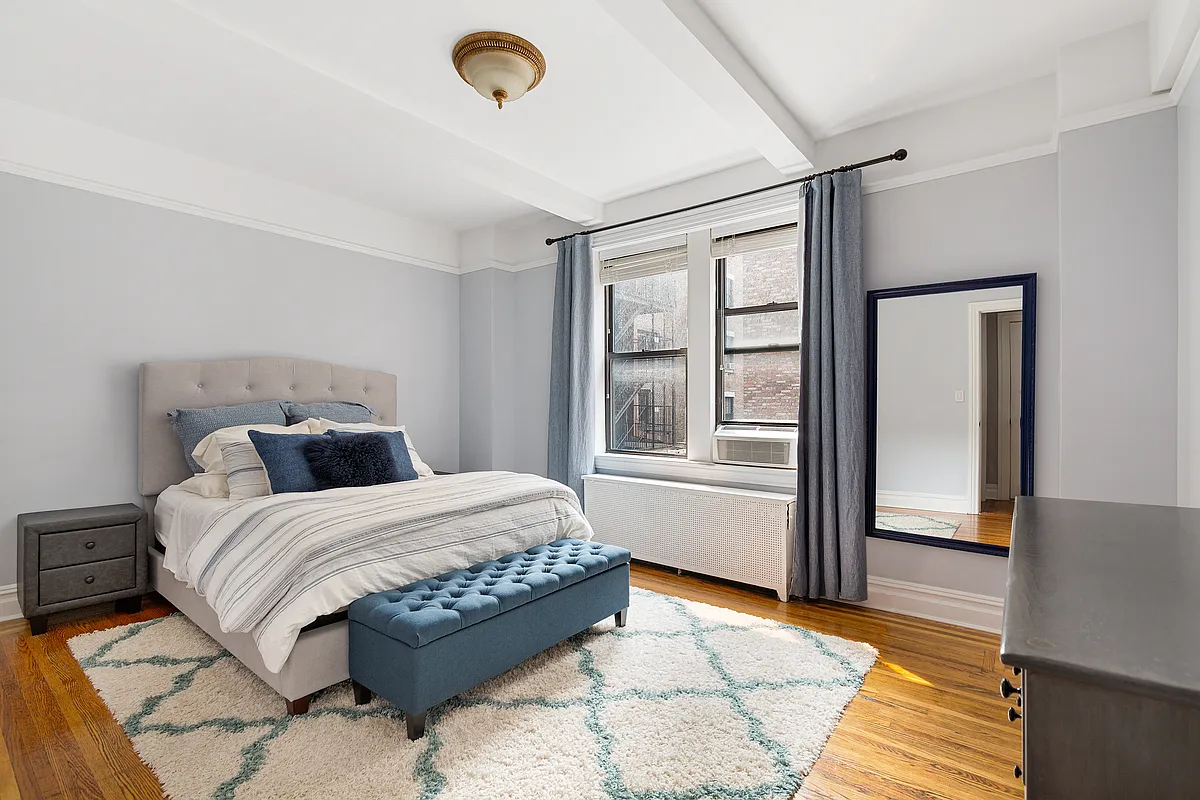 675 West End Avenue, Unit 4C Manhattan, NY 10025 - Photo 4 of 10 a bedroom with a large bed and a window