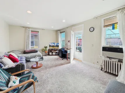 a bedroom with furniture and a window