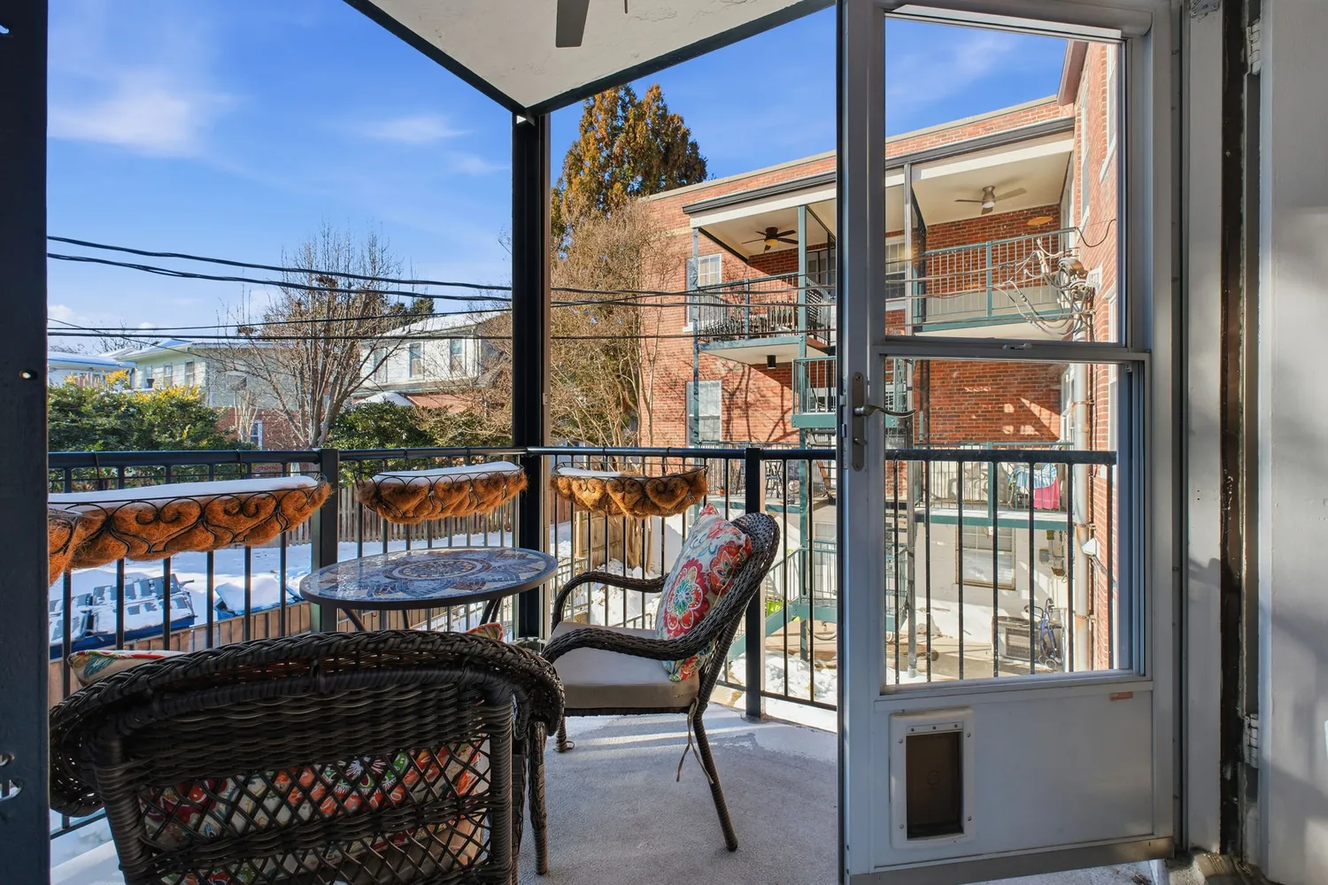 a view of a chairs and table in balcony