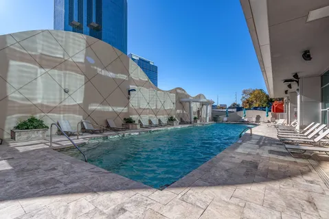 a sign board with tall buildings