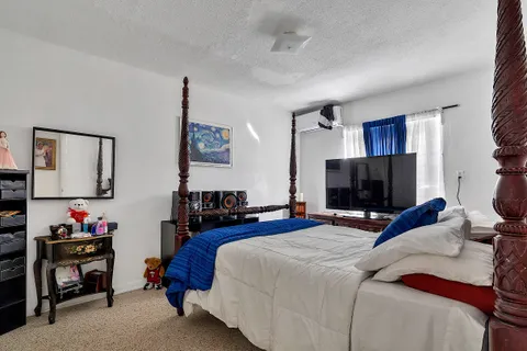 a bedroom with a bed and a flat screen tv