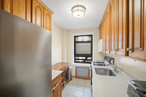 a kitchen with a sink cabinets and a window