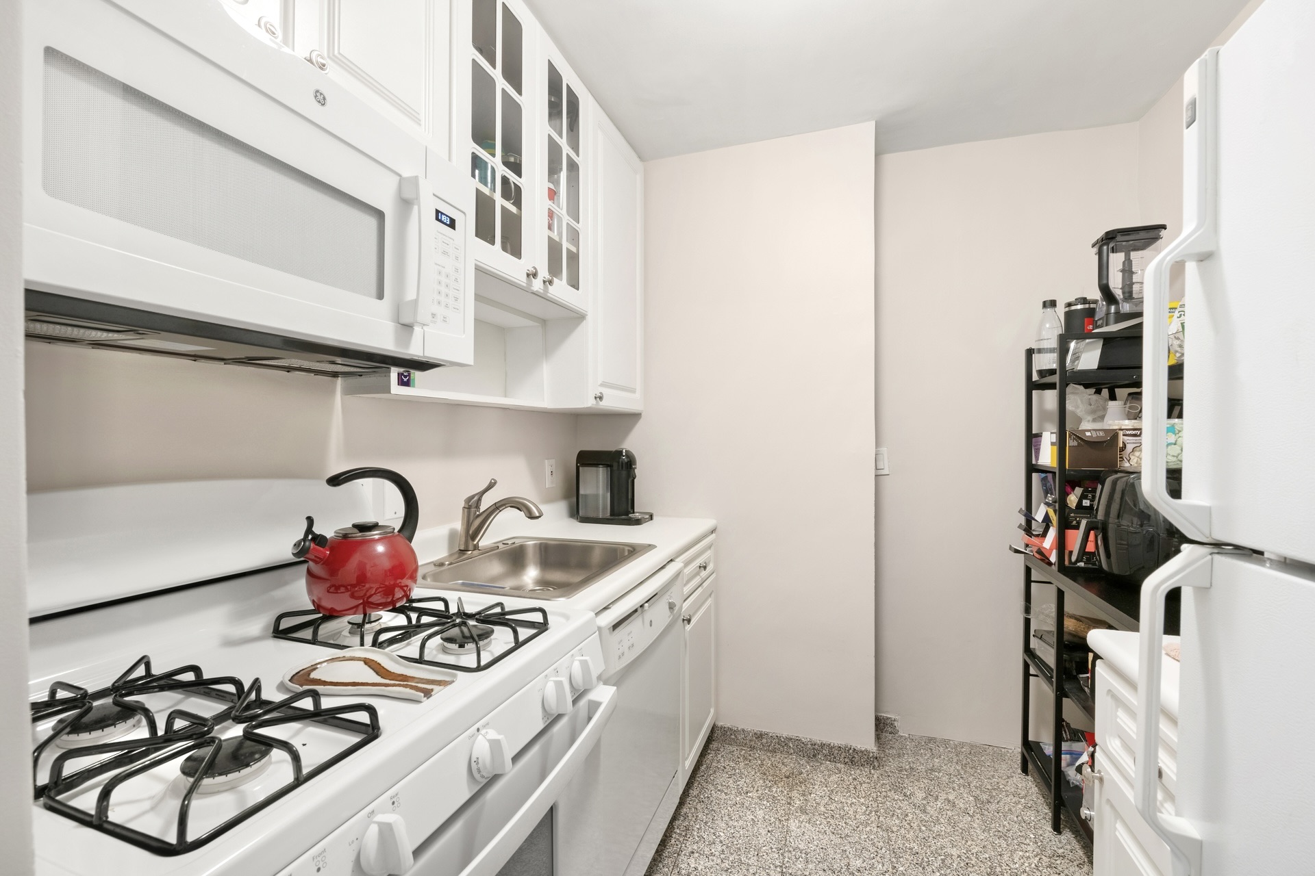 200 East 58th Street, Unit 10J Manhattan, NY 10022 - Photo 5 of 8 a kitchen with a sink and cabinets