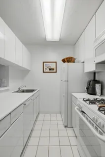 a kitchen with a stove top oven and cabinets
