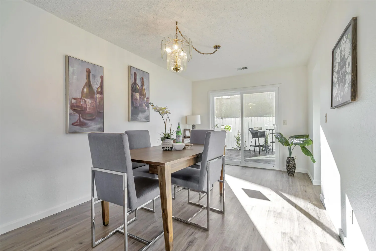 a view of a dining room with furniture and chandelier