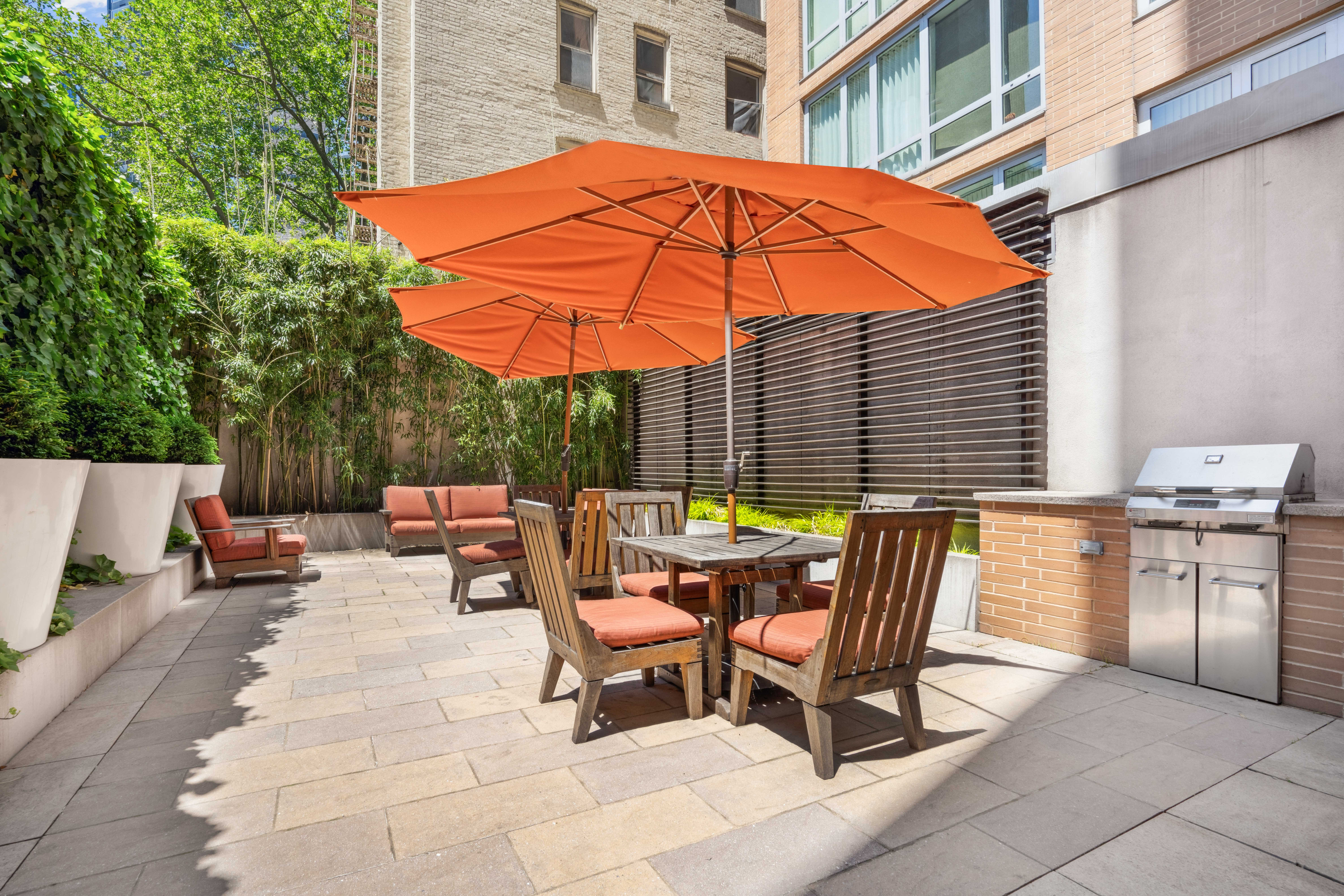 250 East 53rd Street, Unit 1402 Manhattan, NY 10022 - Photo 12 of 13 a patio with a patio table and chairs