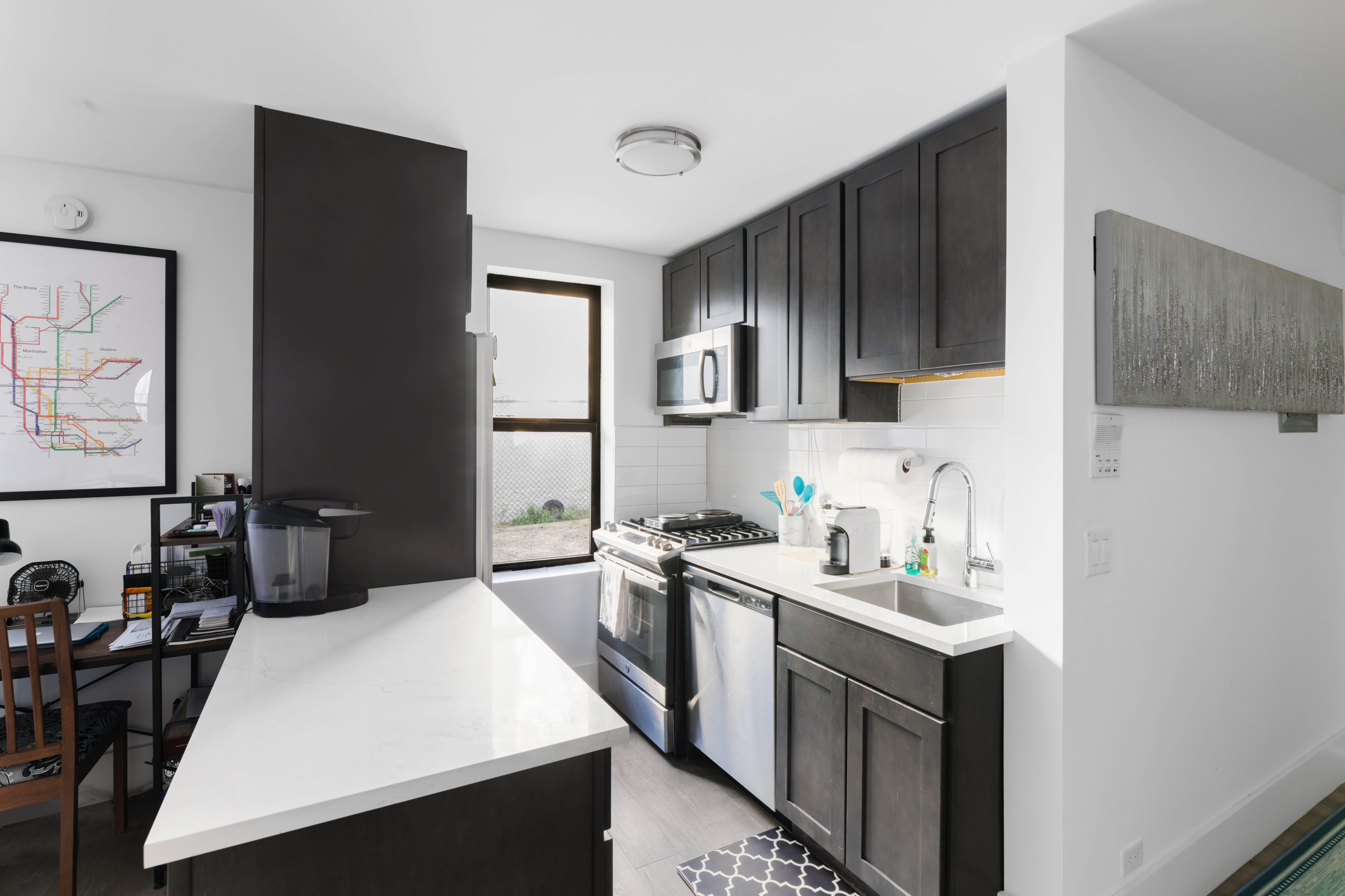 2420 Morris Avenue, Unit 1I Bronx, NY 10468 - Photo 4 of 7 a kitchen with a sink a stove and refrigerator