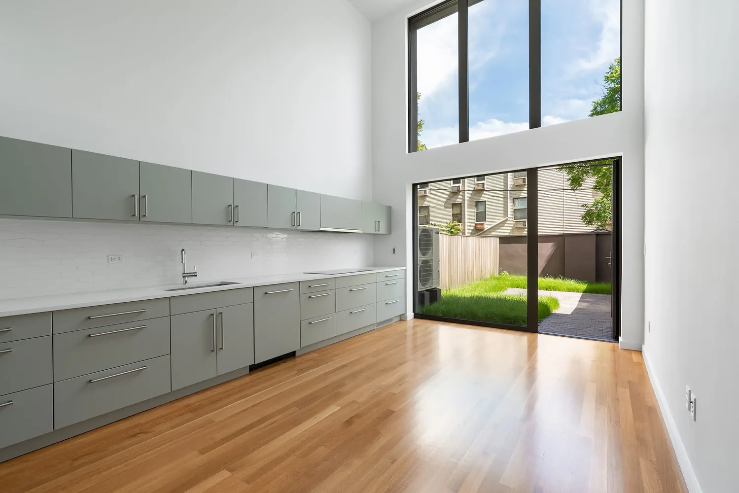 a view of a kitchen with a sink and wooden floor