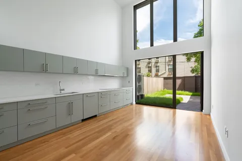 a view of a kitchen with a sink and wooden floor