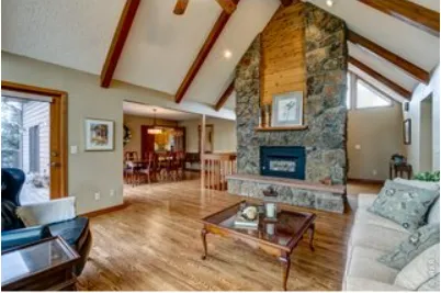 a dining room with furniture wooden floor a chandelier and a rug