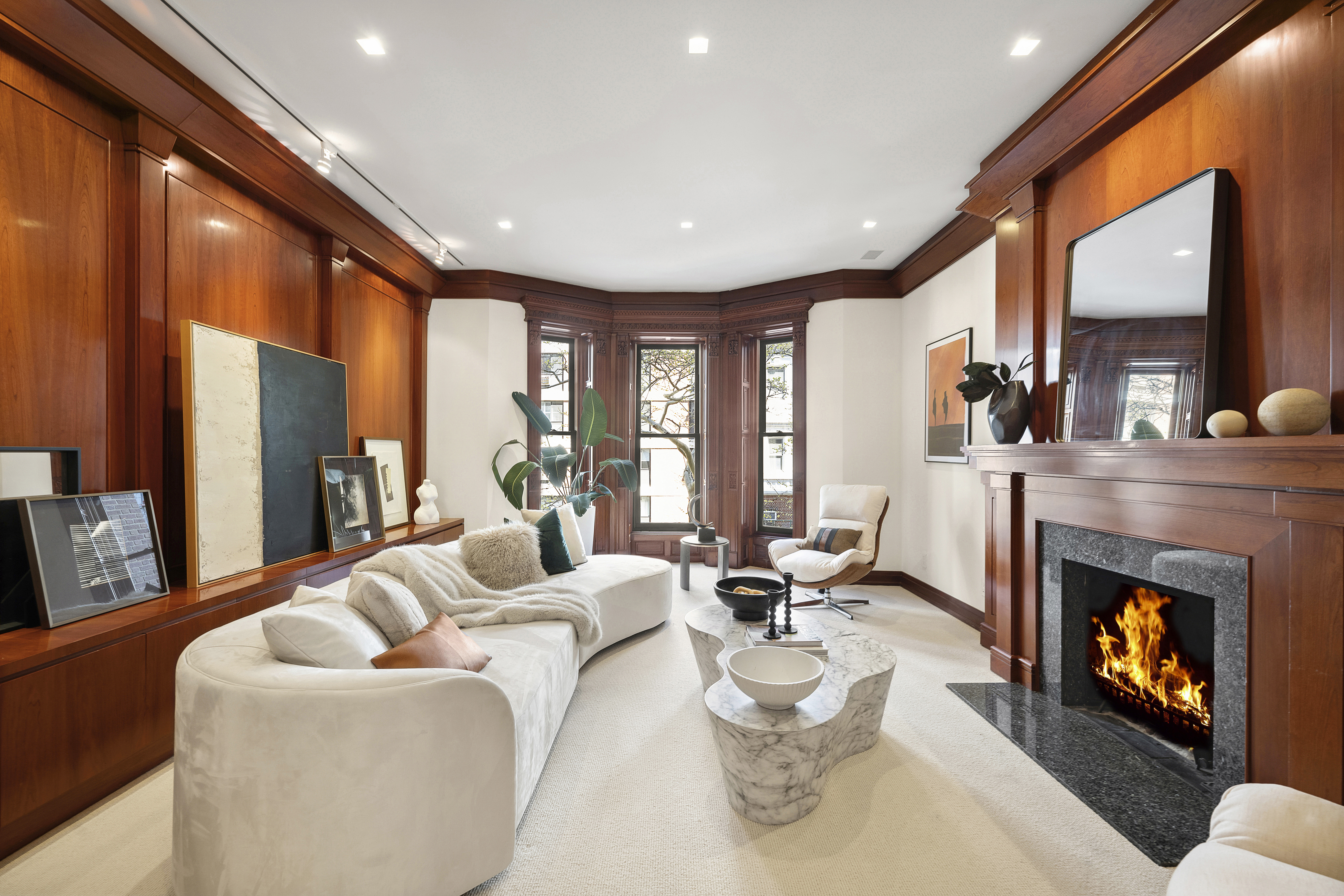 50 East 73rd Street Manhattan, NY 10021 - Photo 15 of 32 a living room with furniture a fireplace and a large window