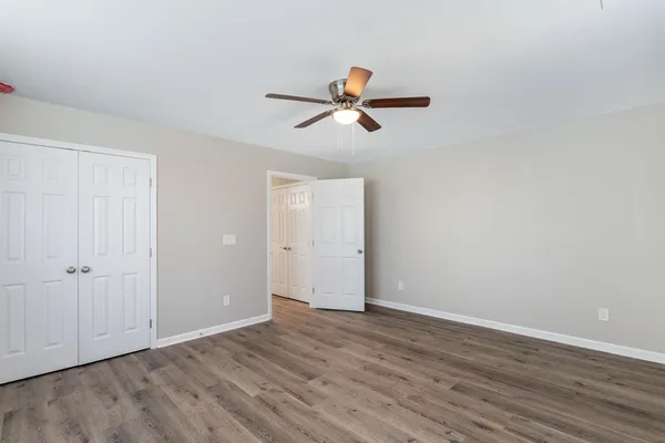 a view of empty room with wooden floor